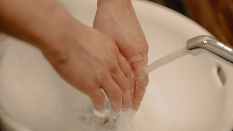 Hands being washed under running water, representing hygiene and clean water